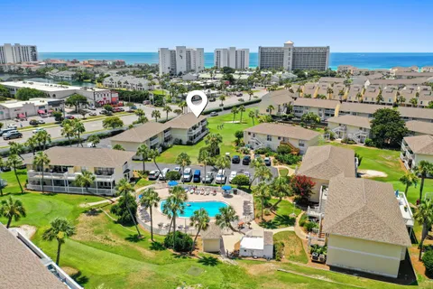 a living room with furniture a flat screen tv and a floor to ceiling window