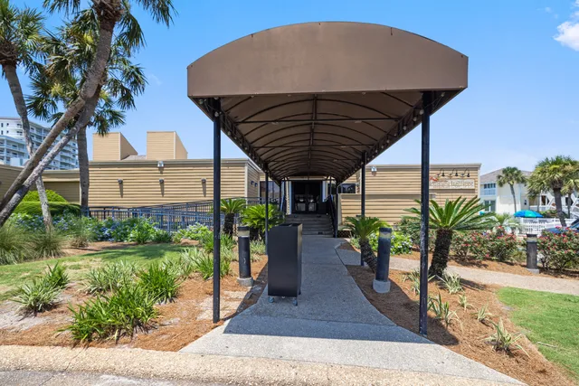 a view of a house with a yard next to a lake
