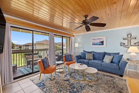 a living room with furniture a rug and a chandelier