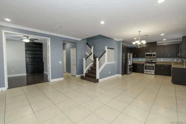 a view of a kitchen with a sink and a refrigerator