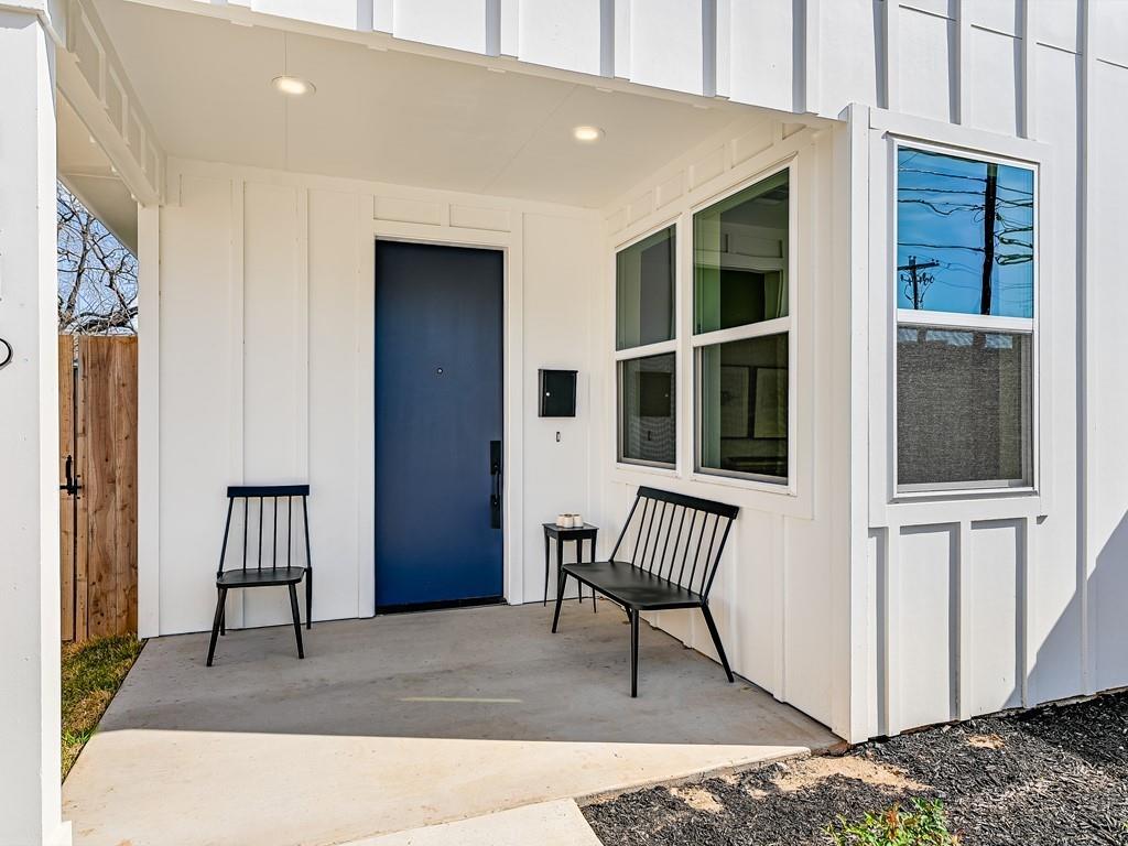 Entrance to property featuring board and batten siding and a patio area