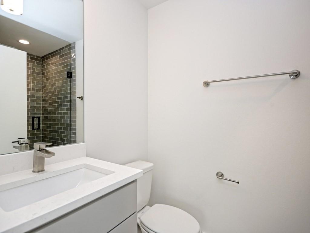 1116 Atkinson Road Austin, TX 78752 - Photo 19 of 27 Bathroom featuring vanity, a shower stall, and recessed lighting