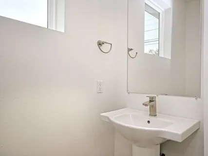 a bathroom with a sink and a window