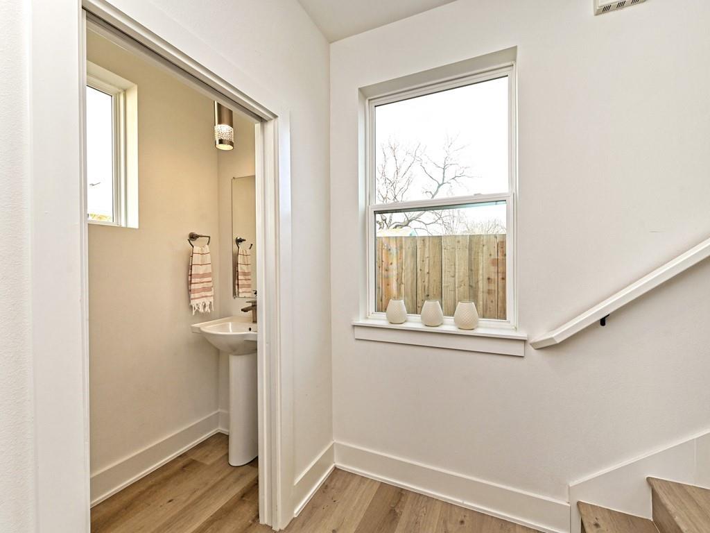 1116 Atkinson Road Austin, TX 78752 - Photo 9 of 27 Bathroom featuring light wood finished floors and baseboards
