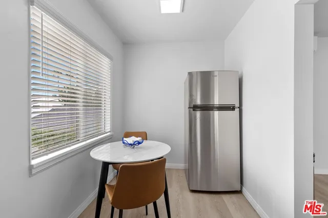 a kitchen with a window and refrigerator