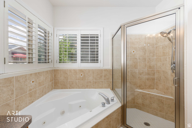 2327 Bluff Ridge Drive Syracuse, UT 84075 - Photo 24 of 66 Corner soaking tub and a separate glass-enclosed shower with a built-in bench