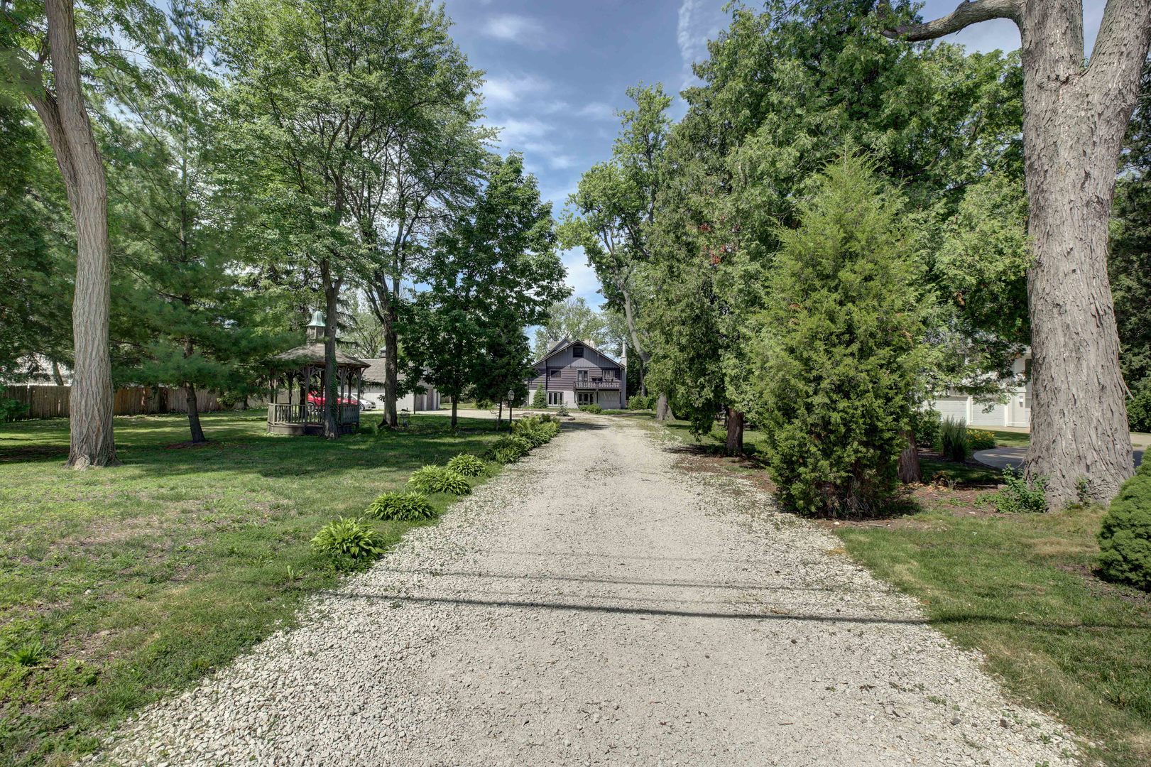 3150 Landwehr Road Northbrook, IL 60062 - Photo 4 of 43 a pathway of a yard with plants and trees