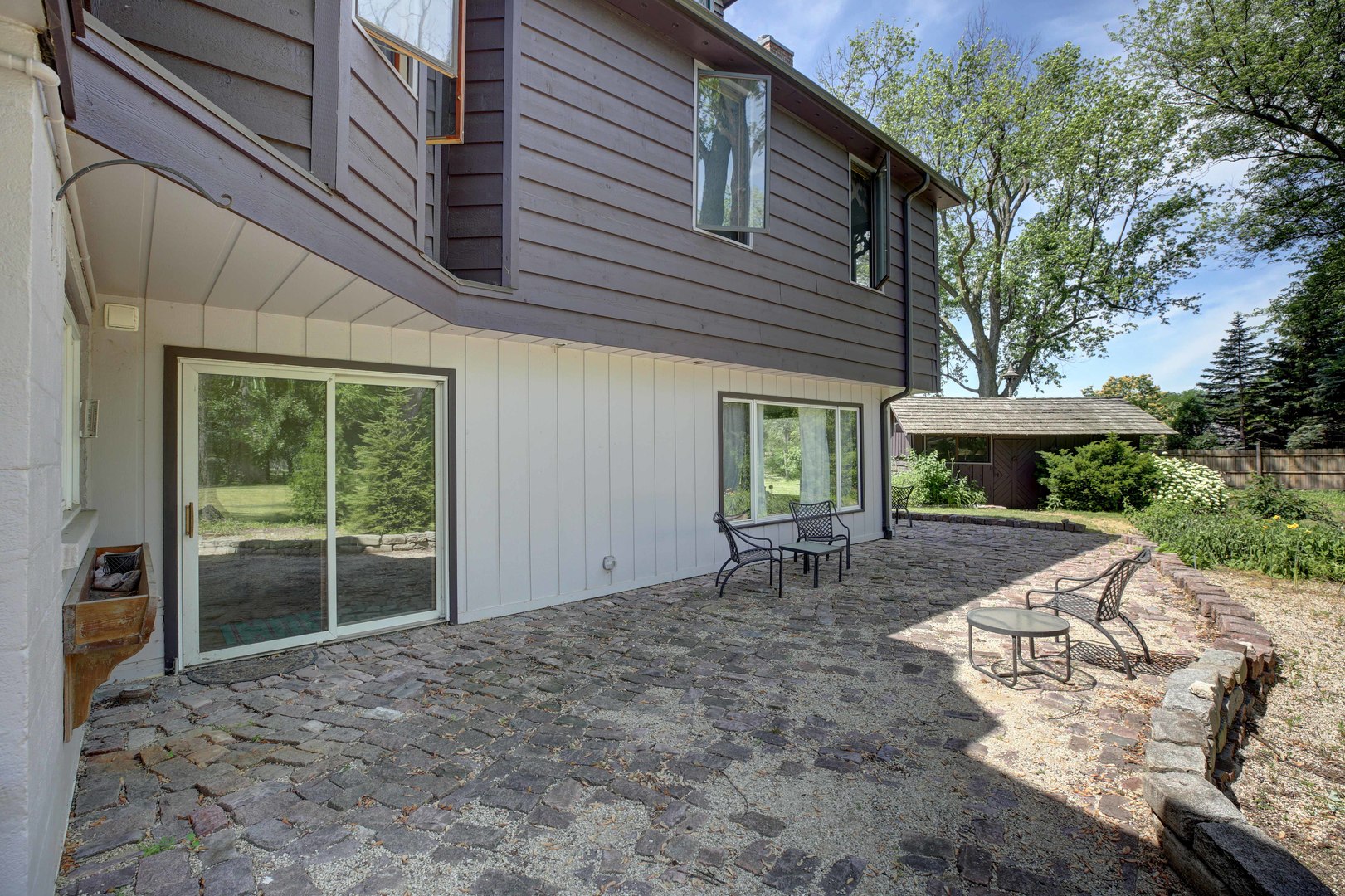 3150 Landwehr Road Northbrook, IL 60062 - Photo 9 of 43 a view of a backyard with table and chairs under an umbrella