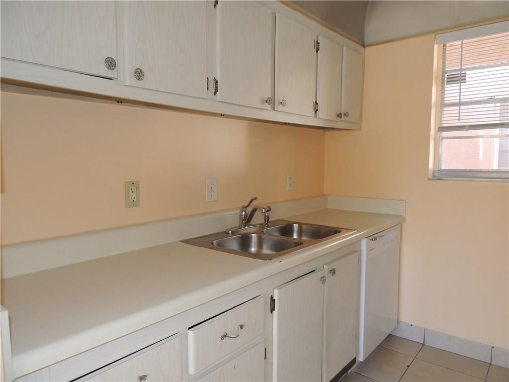 600 Southwest 2nd Avenue, Unit 143 Boca Raton, FL 33432 - Photo 3 of 14 a kitchen with a sink and cabinets