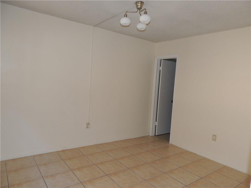 600 Southwest 2nd Avenue, Unit 143 Boca Raton, FL 33432 - Photo 8 of 14 an empty room with a chandelier fan