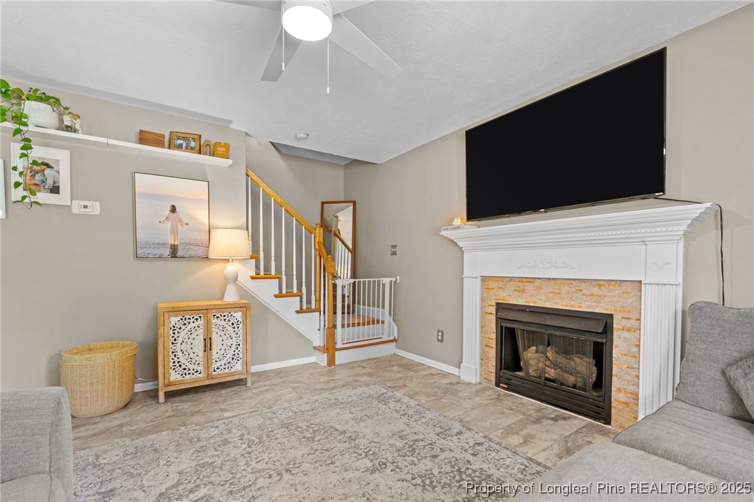 383 Yorkshire Drive Cameron, NC 28326 - Photo 13 of 49 a living room with a fireplace and a flat screen tv