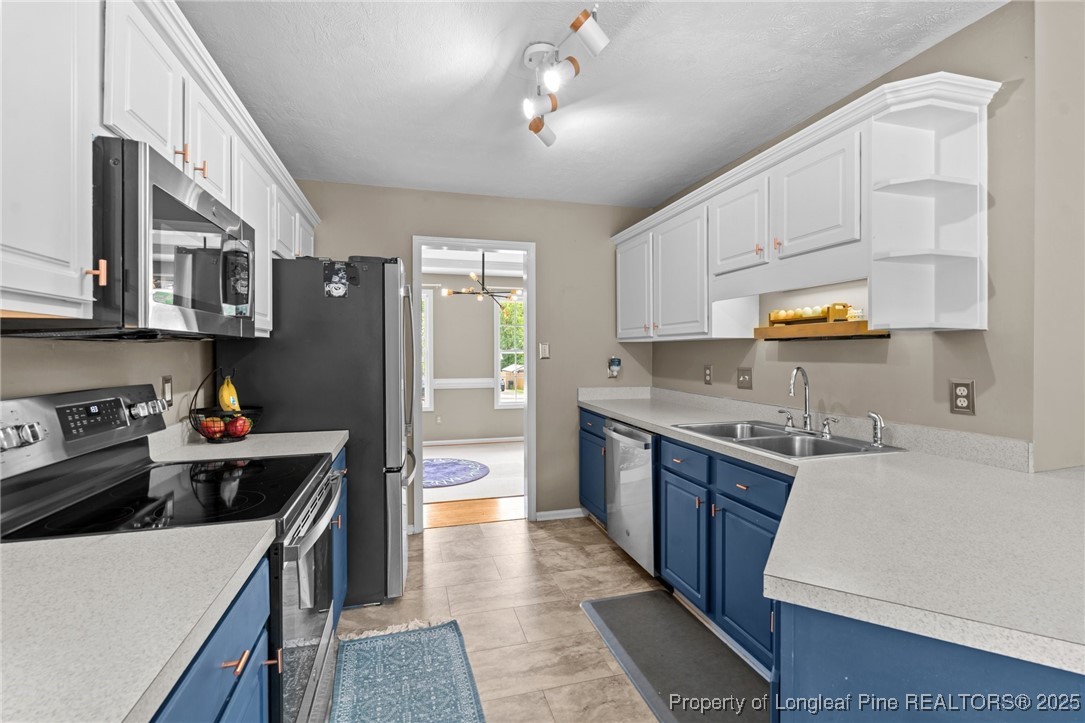 383 Yorkshire Drive Cameron, NC 28326 - Photo 18 of 49 a kitchen with a stove a refrigerator and a sink