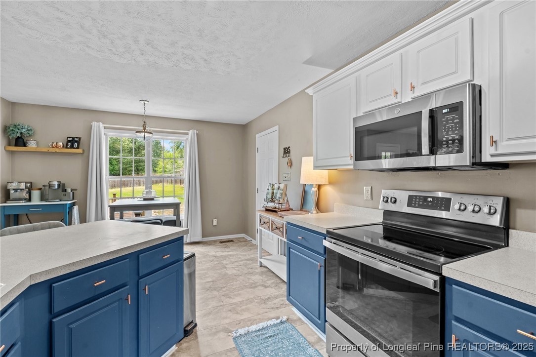 383 Yorkshire Drive Cameron, NC 28326 - Photo 20 of 49 a kitchen with a stove microwave and sink