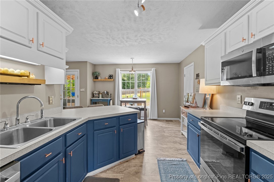 383 Yorkshire Drive Cameron, NC 28326 - Photo 21 of 49 a kitchen with a sink stove and microwave