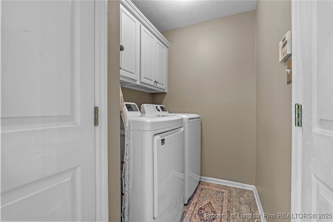 383 Yorkshire Drive Cameron, NC 28326 - Photo 23 of 49 a utility room with cabinets washer and dryer