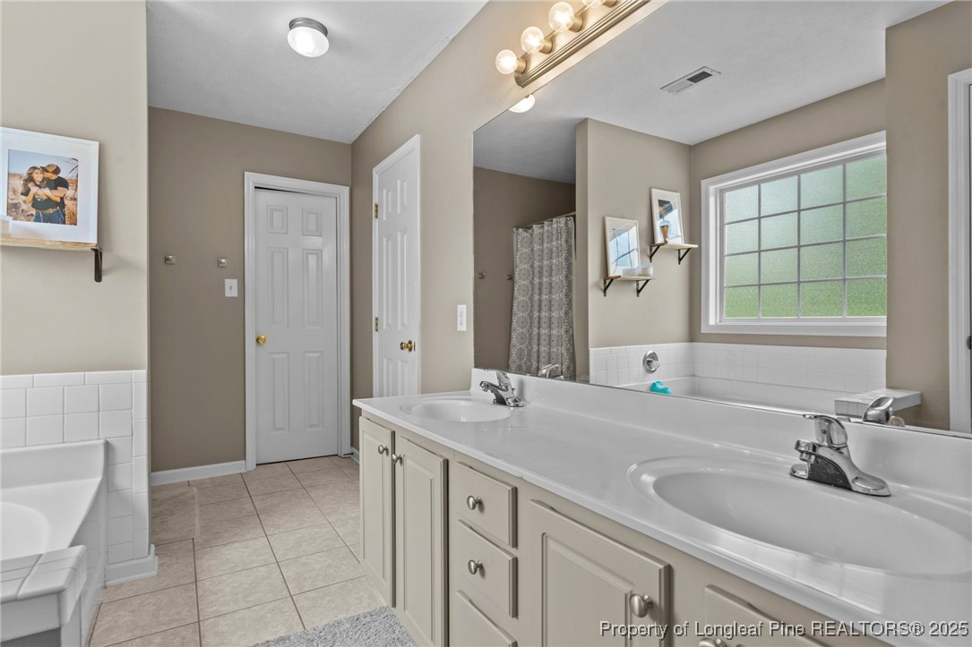 383 Yorkshire Drive Cameron, NC 28326 - Photo 25 of 49 a bathroom with a sink double vanity and a mirror