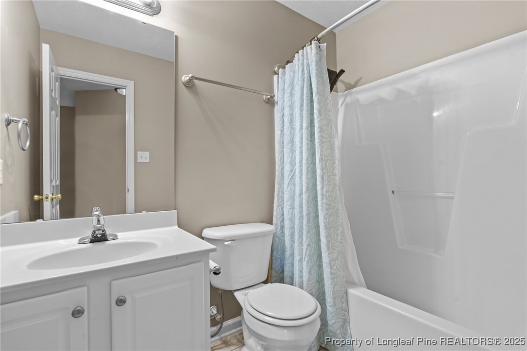 383 Yorkshire Drive Cameron, NC 28326 - Photo 31 of 49 a bathroom with a sink a toilet a mirror and shower