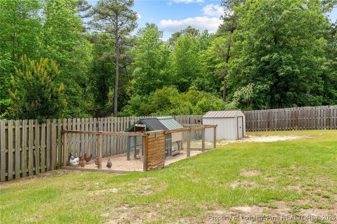 383 Yorkshire Drive Cameron, NC 28326 - Photo 42 of 49 a view of a deck with table and chairs and wooden fence