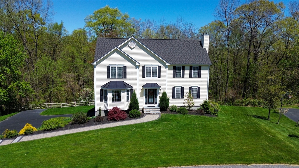 33 Boundary Stone Road Sutton, MA 01590 - Photo 1 of 39 a front view of a house with a garden and trees