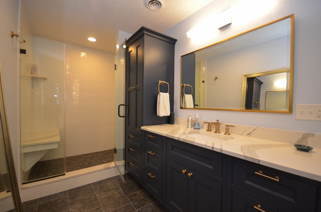 33 Boundary Stone Road Sutton, MA 01590 - Photo 21 of 39 a bathroom with a double vanity sink and a mirror