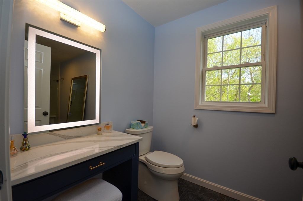 33 Boundary Stone Road Sutton, MA 01590 - Photo 22 of 39 a bathroom with a sink a toilet and window