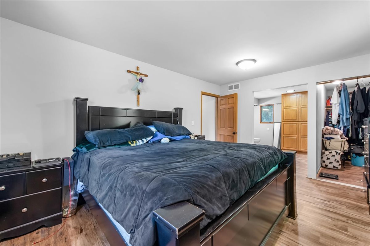 1834 Fischer Road South Beloit, IL 61080 - Photo 17 of 46 a bedroom with a bed and wooden floor