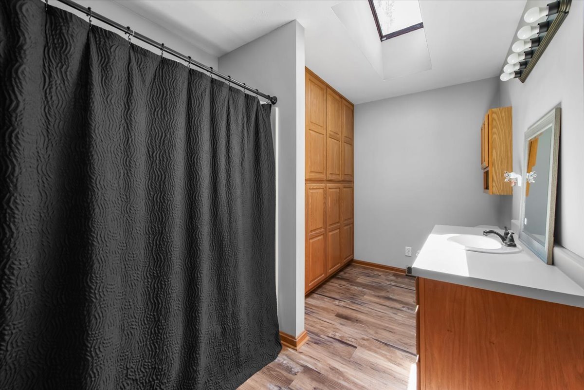 1834 Fischer Road South Beloit, IL 61080 - Photo 20 of 46 a bathroom with a sink a mirror and a shower