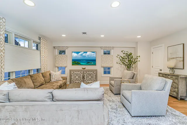 a living room with furniture potted plant and a window