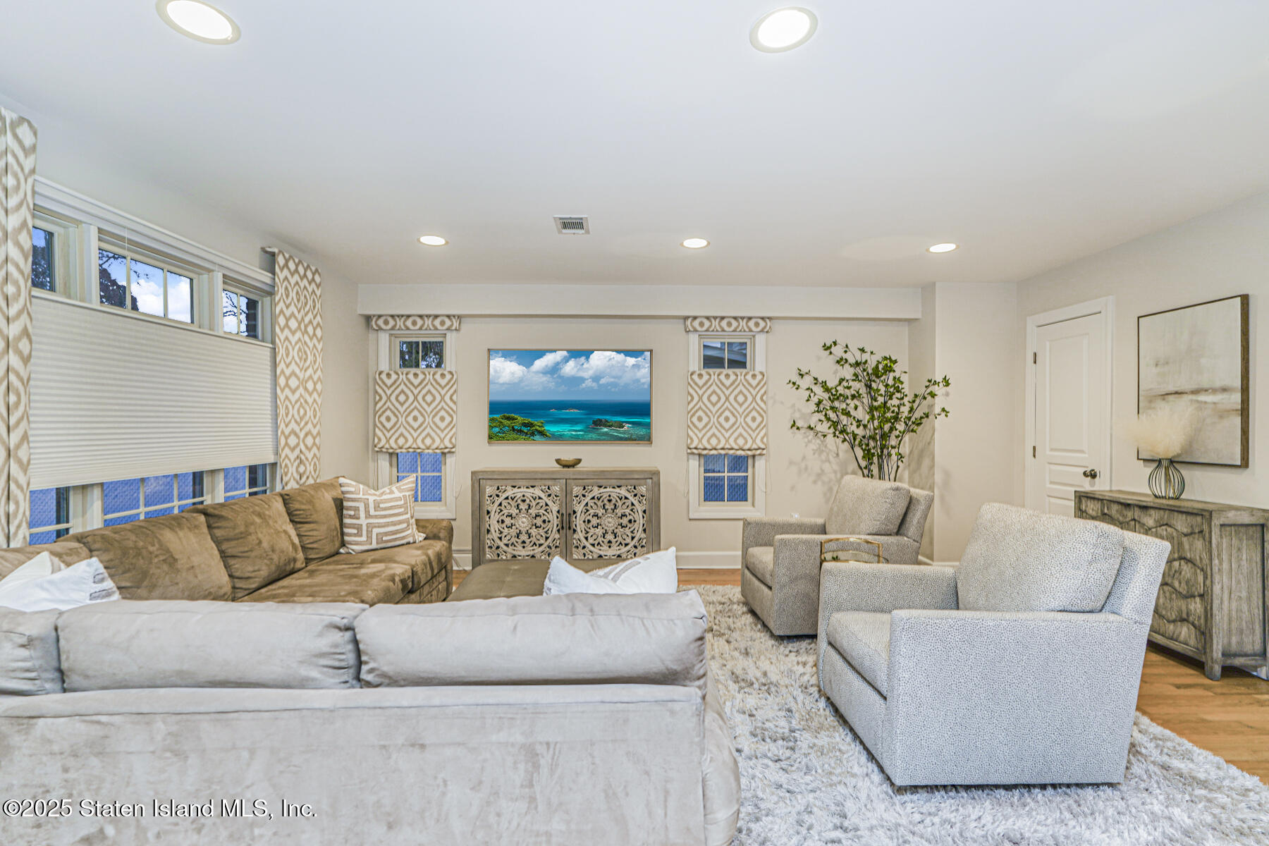 133 Goodwin Avenue Staten Island, NY 10314 - Photo 19 of 54 a living room with furniture and a flat screen tv