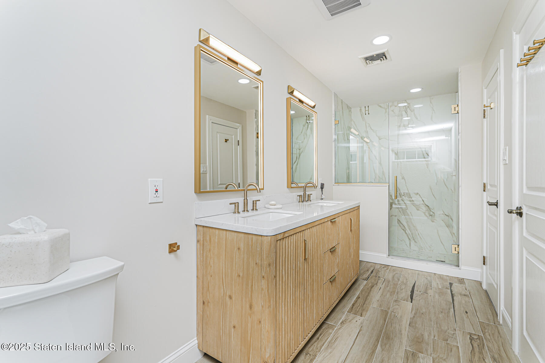 133 Goodwin Avenue Staten Island, NY 10314 - Photo 26 of 54 a bathroom with a double vanity sink mirror and toilet