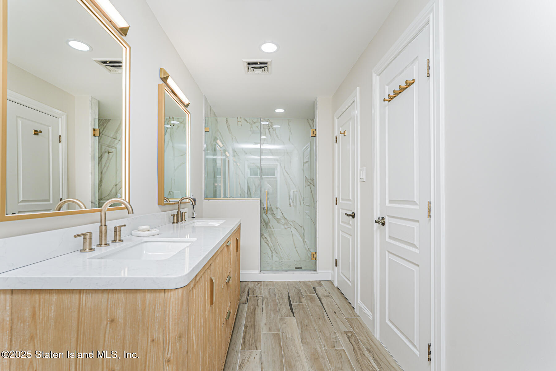 133 Goodwin Avenue Staten Island, NY 10314 - Photo 27 of 54 a bathroom with sink a mirror a vanity and shower