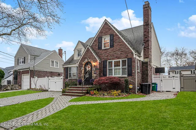 a front view of house with yard and green space