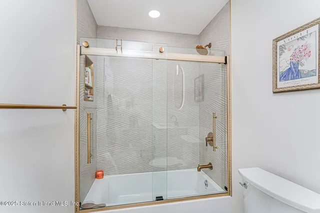 a bedroom with a bed and a night stand