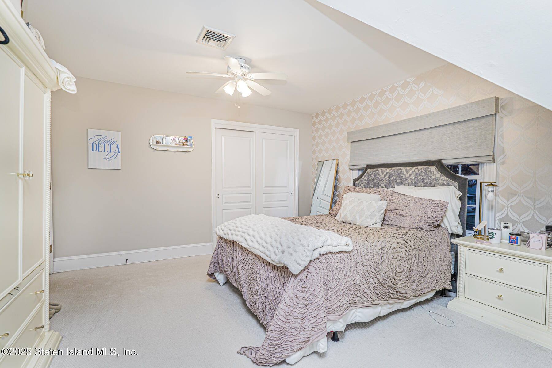 133 Goodwin Avenue Staten Island, NY 10314 - Photo 35 of 54 a bedroom with a bed and a night stand