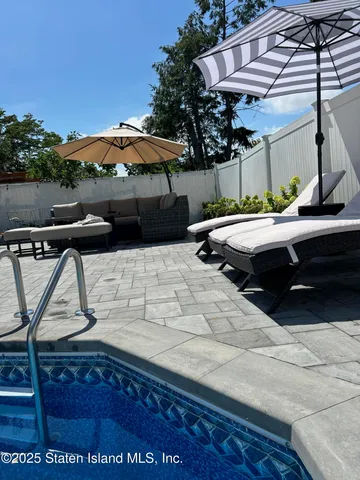 a backyard of a house with table and chairs