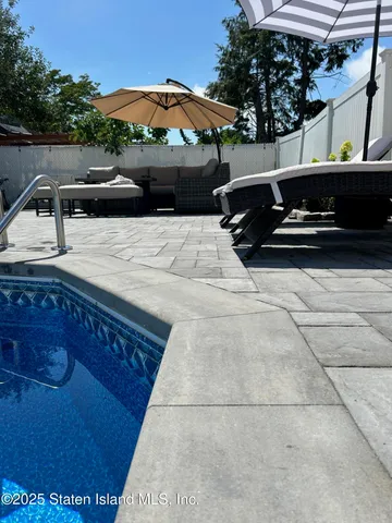 a view of outdoor space with swimming pool and patio