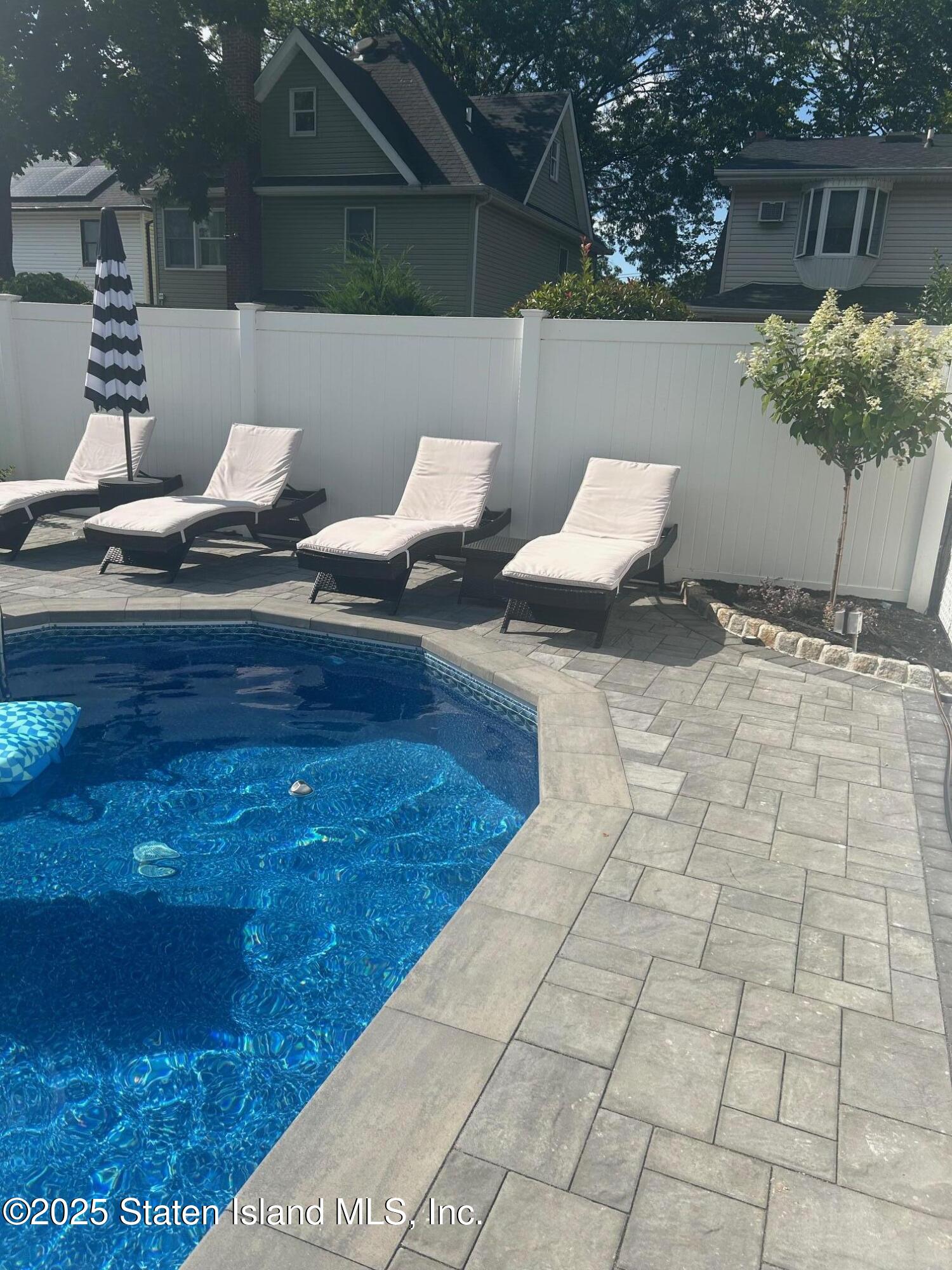 133 Goodwin Avenue Staten Island, NY 10314 - Photo 42 of 54 a backyard of a house with table and chairs