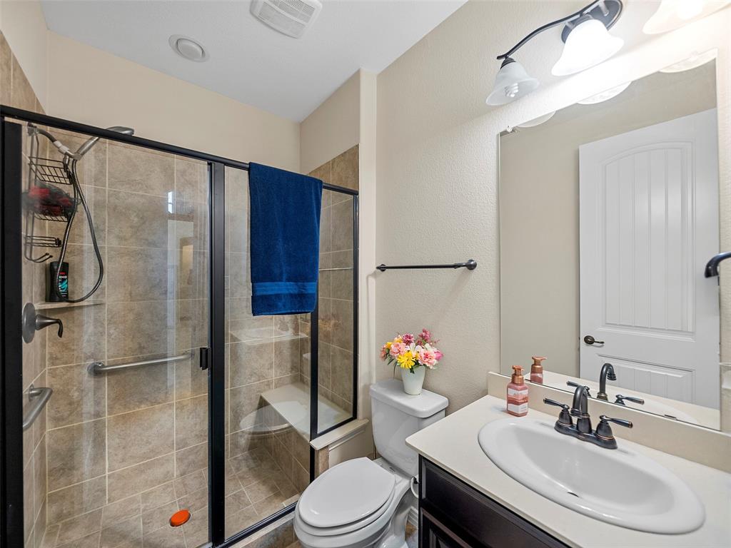 5207 Seth Avenue Sachse, TX 75048 - Photo 14 of 28 Full bathroom with vanity, toilet, and a shower stall