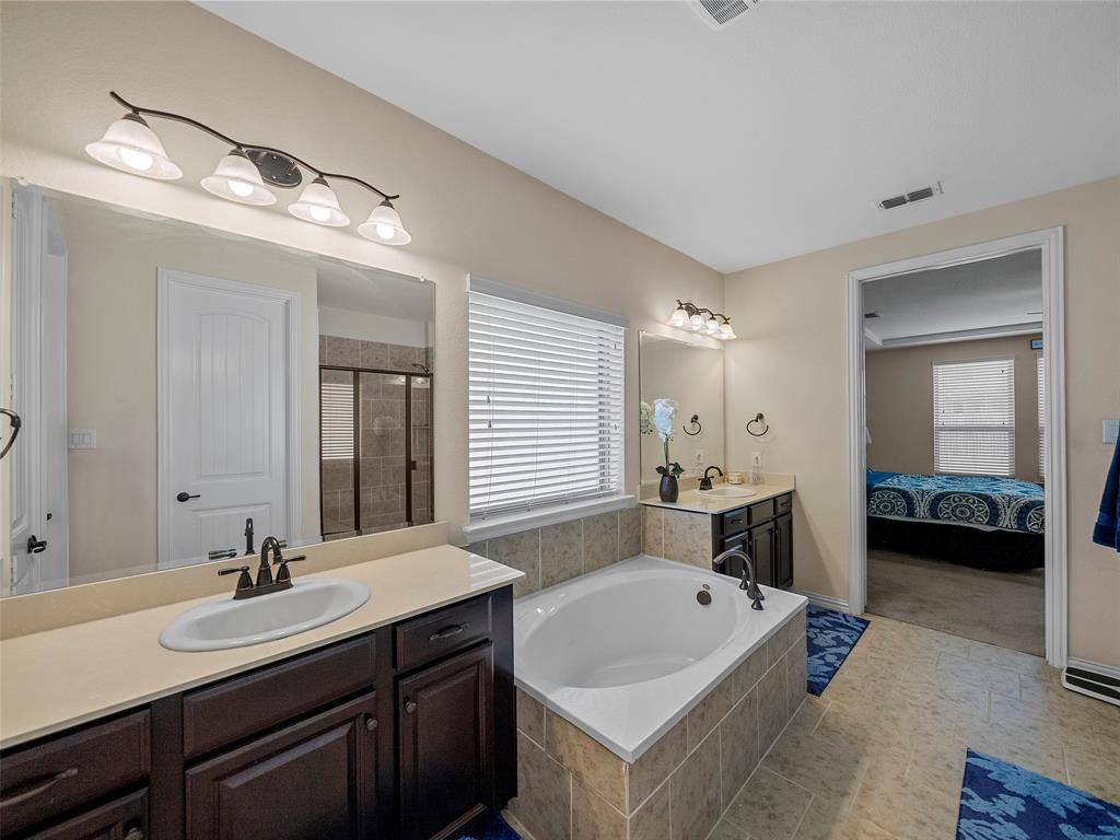 5207 Seth Avenue Sachse, TX 75048 - Photo 18 of 28 Full bathroom featuring a garden tub, two vanities, a shower stall, and ensuite bath