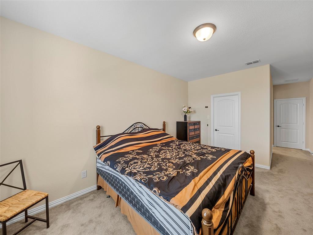 5207 Seth Avenue Sachse, TX 75048 - Photo 19 of 28 Bedroom featuring light carpet and baseboards