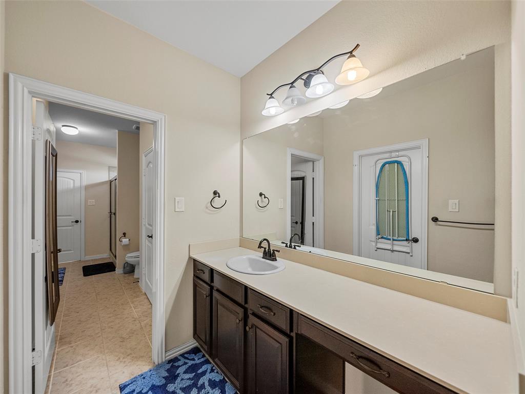 5207 Seth Avenue Sachse, TX 75048 - Photo 22 of 28 Bathroom with vanity, toilet, tile patterned floors, and a shower