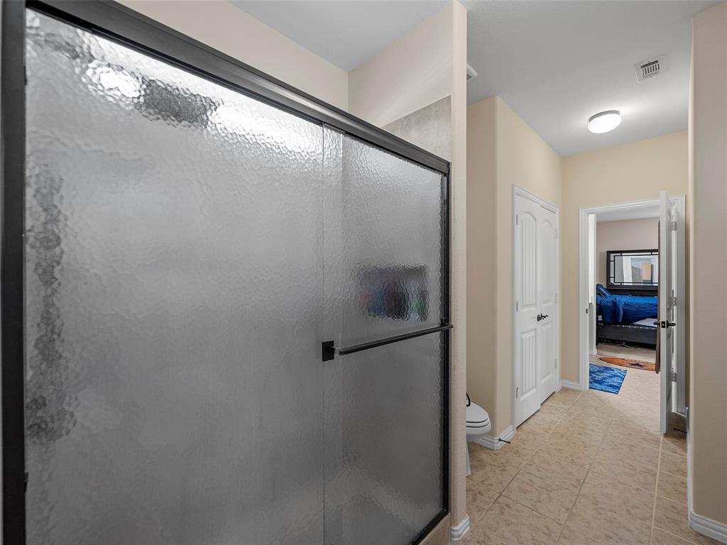 5207 Seth Avenue Sachse, TX 75048 - Photo 23 of 28 Full bath with a shower stall, toilet, tile patterned floors, baseboards, and ensuite bathroom