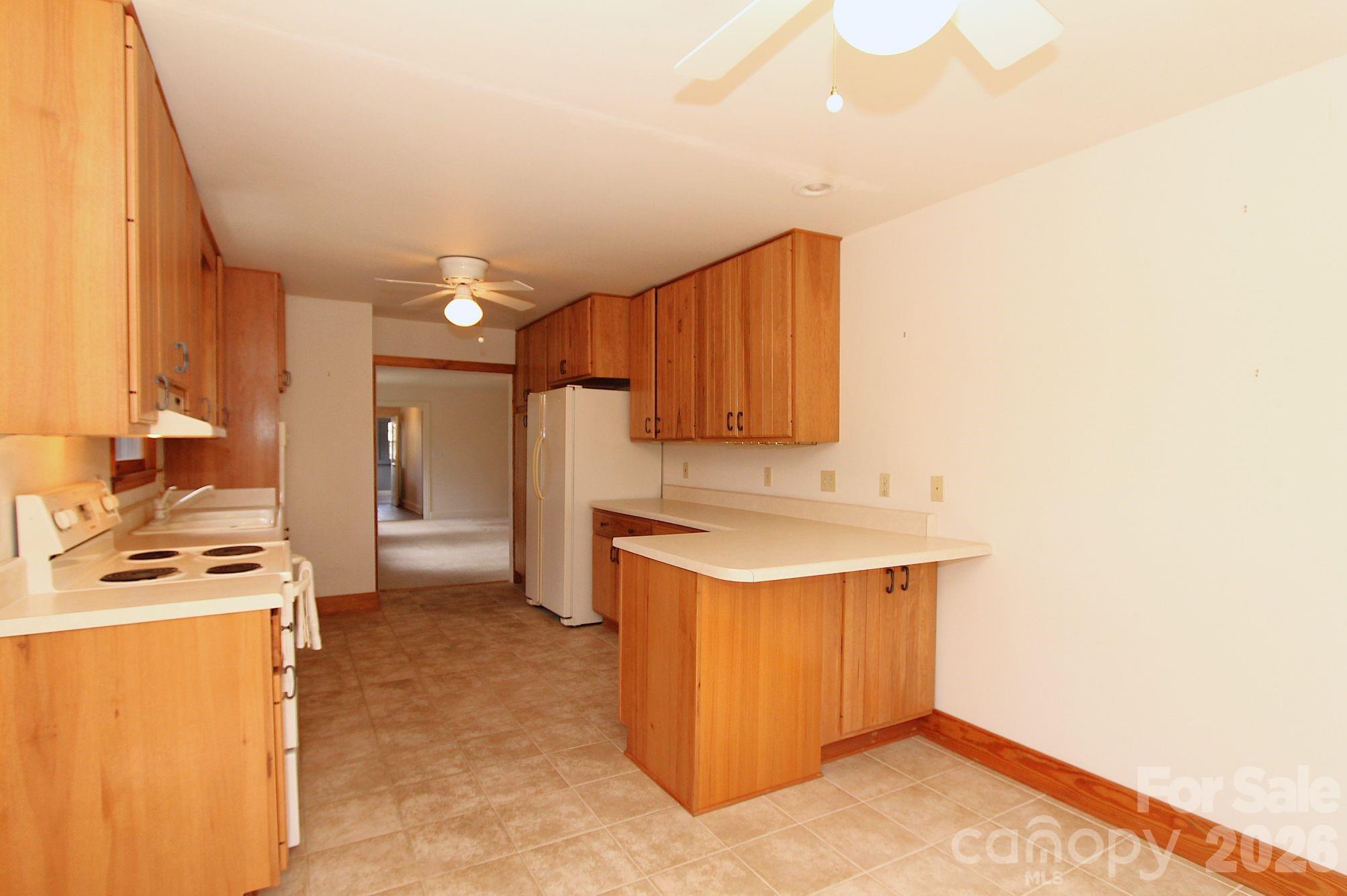 407 Turley Falls Road Hendersonville, NC 28739 - Photo 11 of 28 a kitchen that has a sink and a stove in it