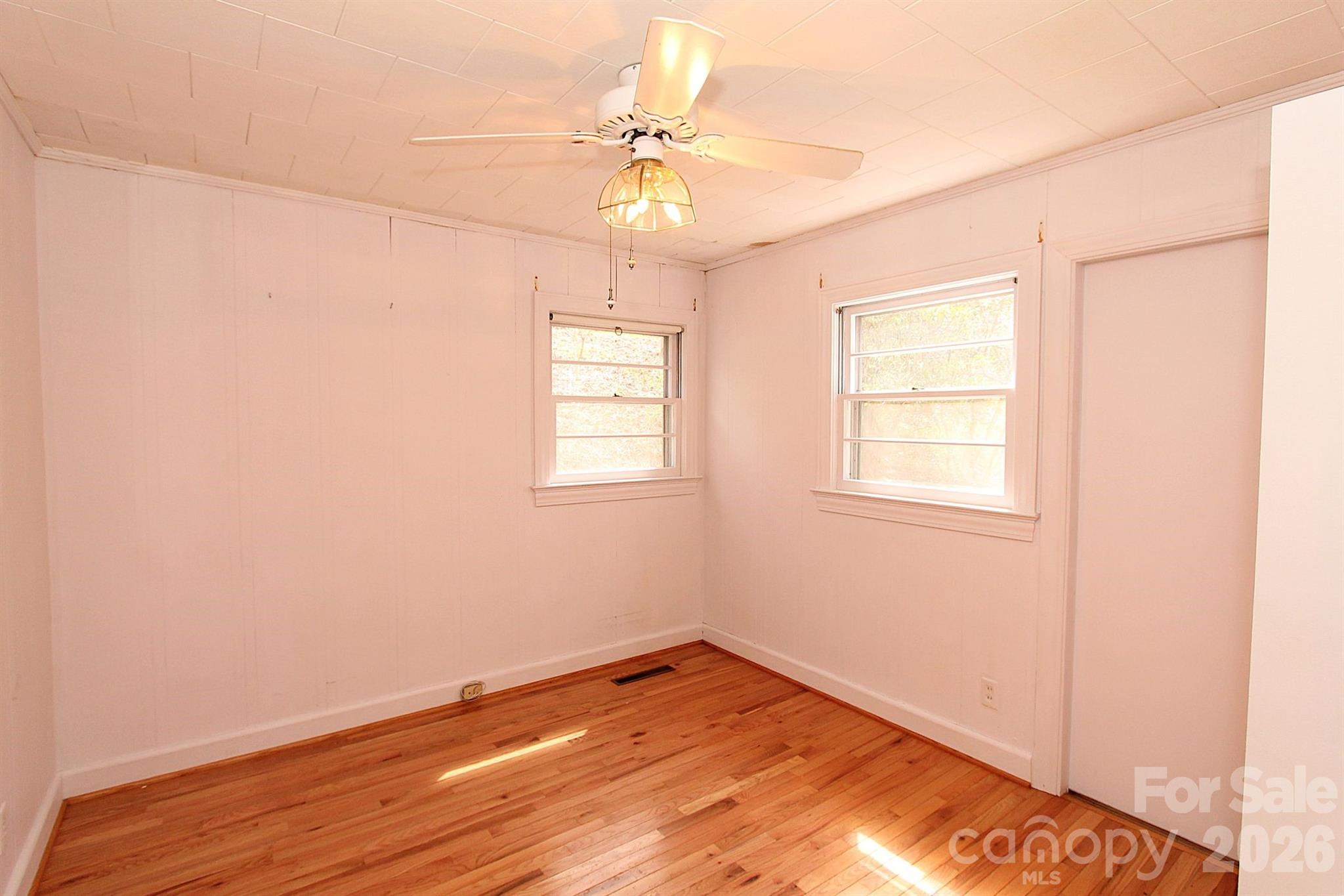 407 Turley Falls Road Hendersonville, NC 28739 - Photo 17 of 28 an empty room with a window and a ceiling fan