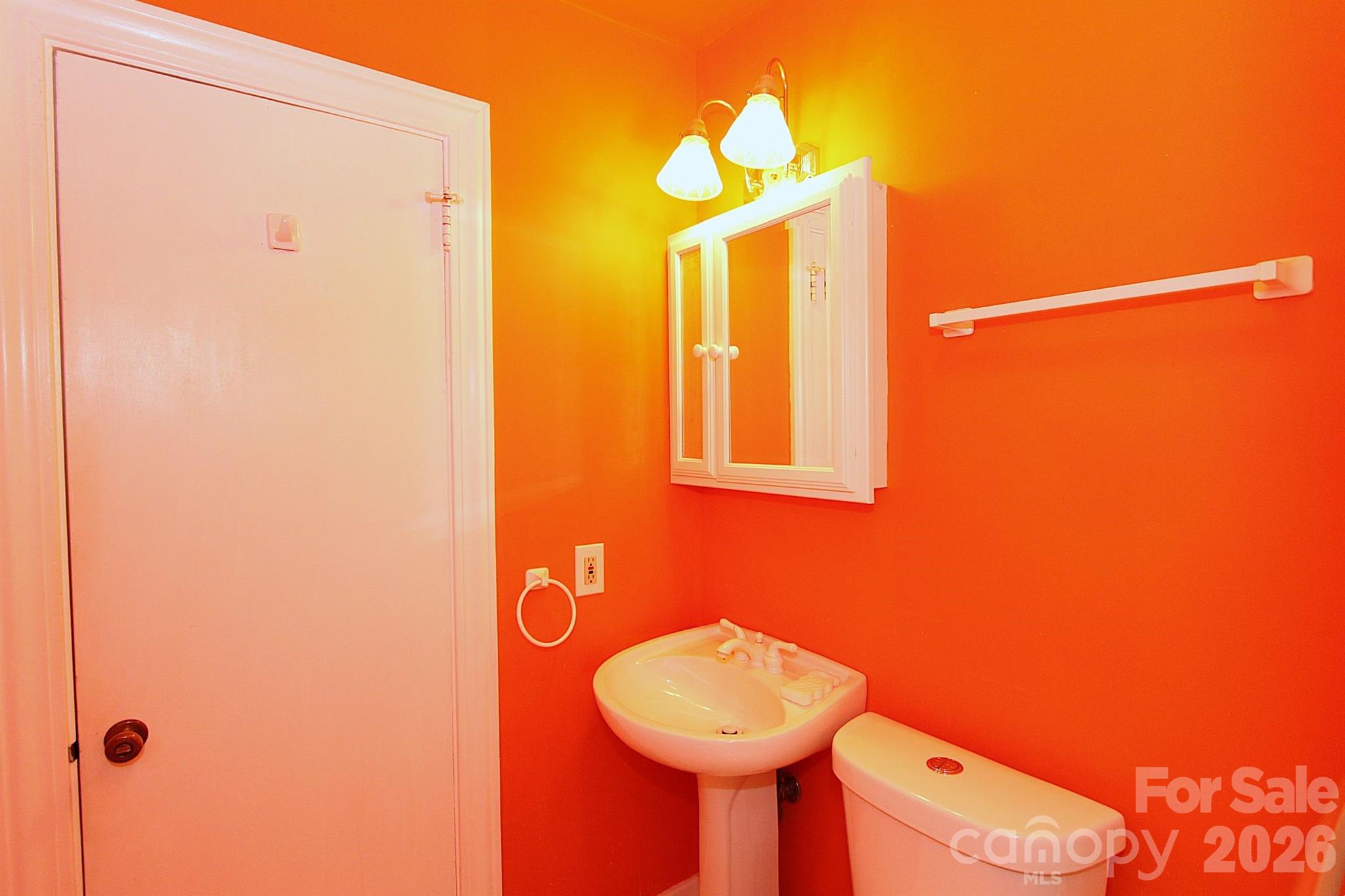 407 Turley Falls Road Hendersonville, NC 28739 - Photo 20 of 28 a bathroom with a sink mirror and toilet