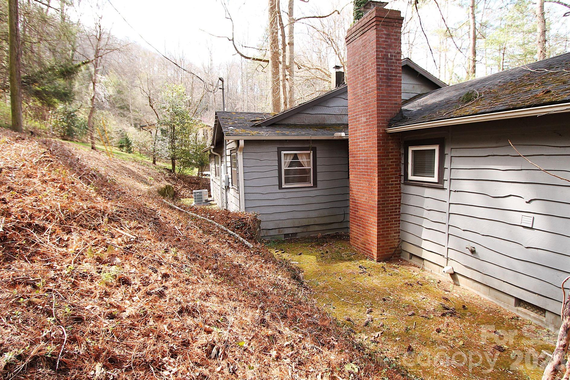 407 Turley Falls Road Hendersonville, NC 28739 - Photo 26 of 28 a view of a house with a yard