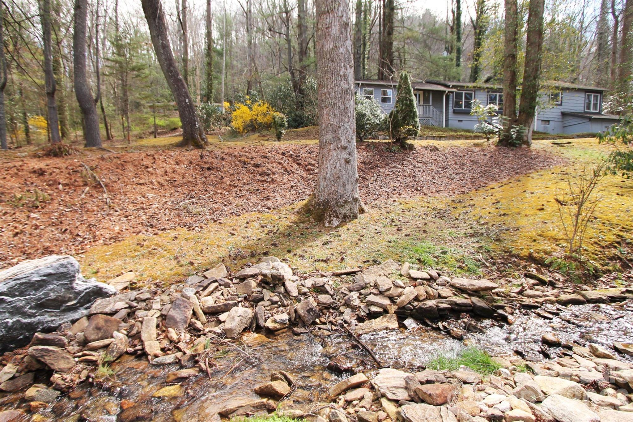 407 Turley Falls Road Hendersonville, NC 28739 - Photo 3 of 28 a view of a yard with yellow lighting