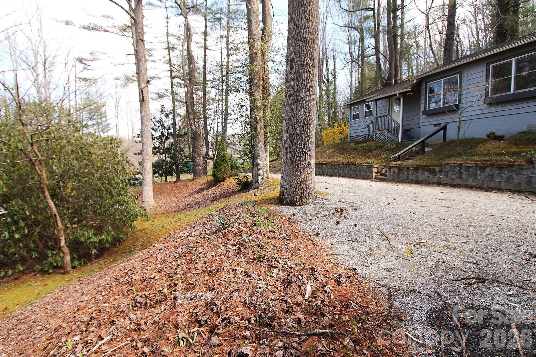 407 Turley Falls Road Hendersonville, NC 28739 - Photo 5 of 28 a backyard of a house with lots of green space
