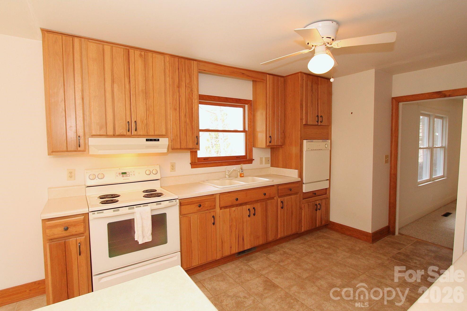 407 Turley Falls Road Hendersonville, NC 28739 - Photo 10 of 28 a kitchen with stainless steel appliances granite countertop a stove a sink and a refrigerator