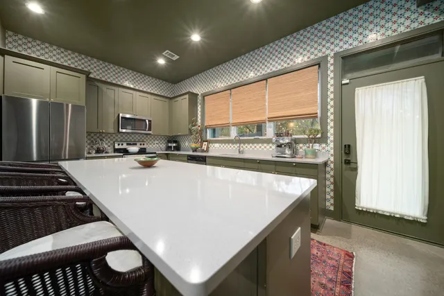 a kitchen with a stove a sink and a refrigerator